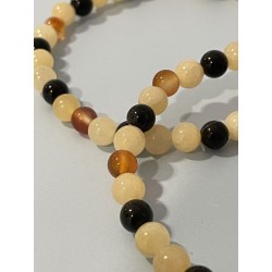 Détail des perles en calcite orange, obsidienne noire et cornaline du bracelet L’Orage Endormi.
