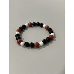 L’Ombre du Clan – Bracelet en onyx, jaspe rouge et quartz neige, aux nuances de noir, rouge et blanc.