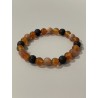 L’Héritier du Dragon – Bracelet en lave, cornaline et pierre de soleil naturelle, aux nuances de noir, orange et doré.